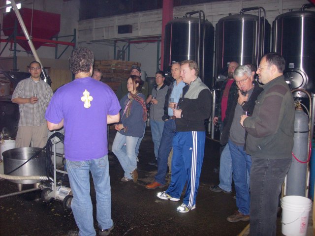 group standing in front of primary fermentation tanks