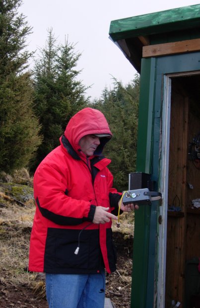 Frank retrieves wattmeter from shack.